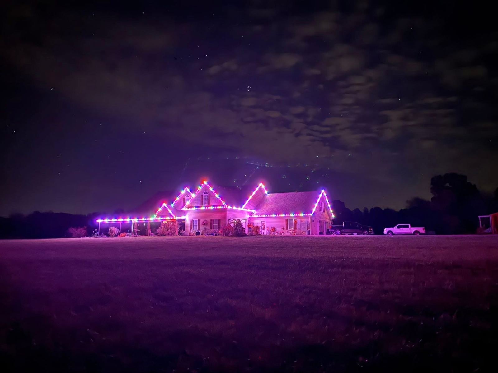 Home with color-changing permanent lighting at night