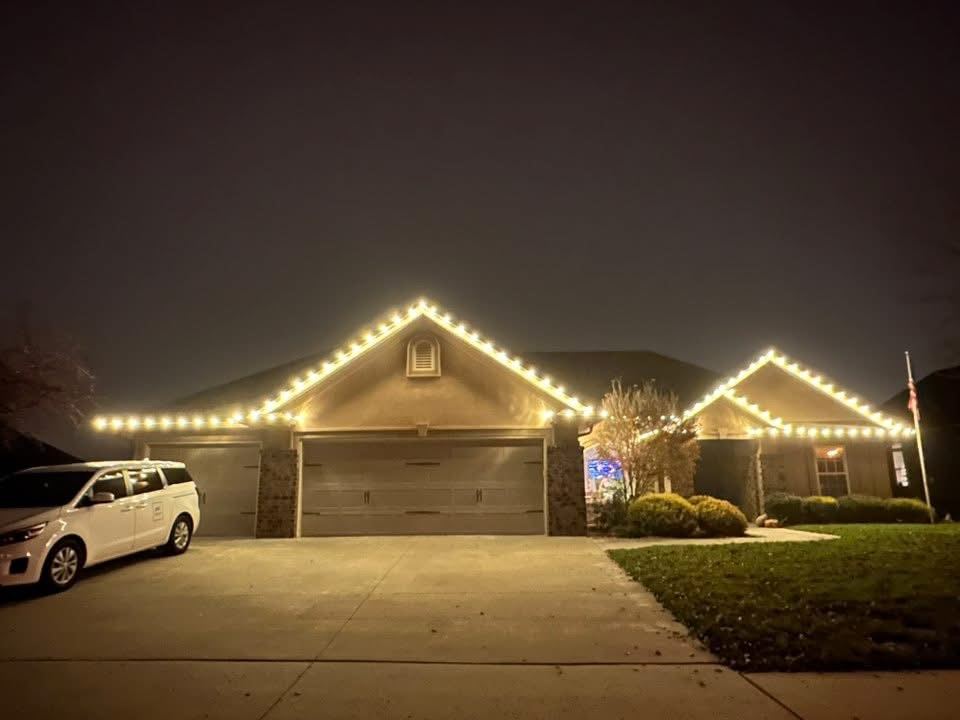 Ranch home with three-car garage lit