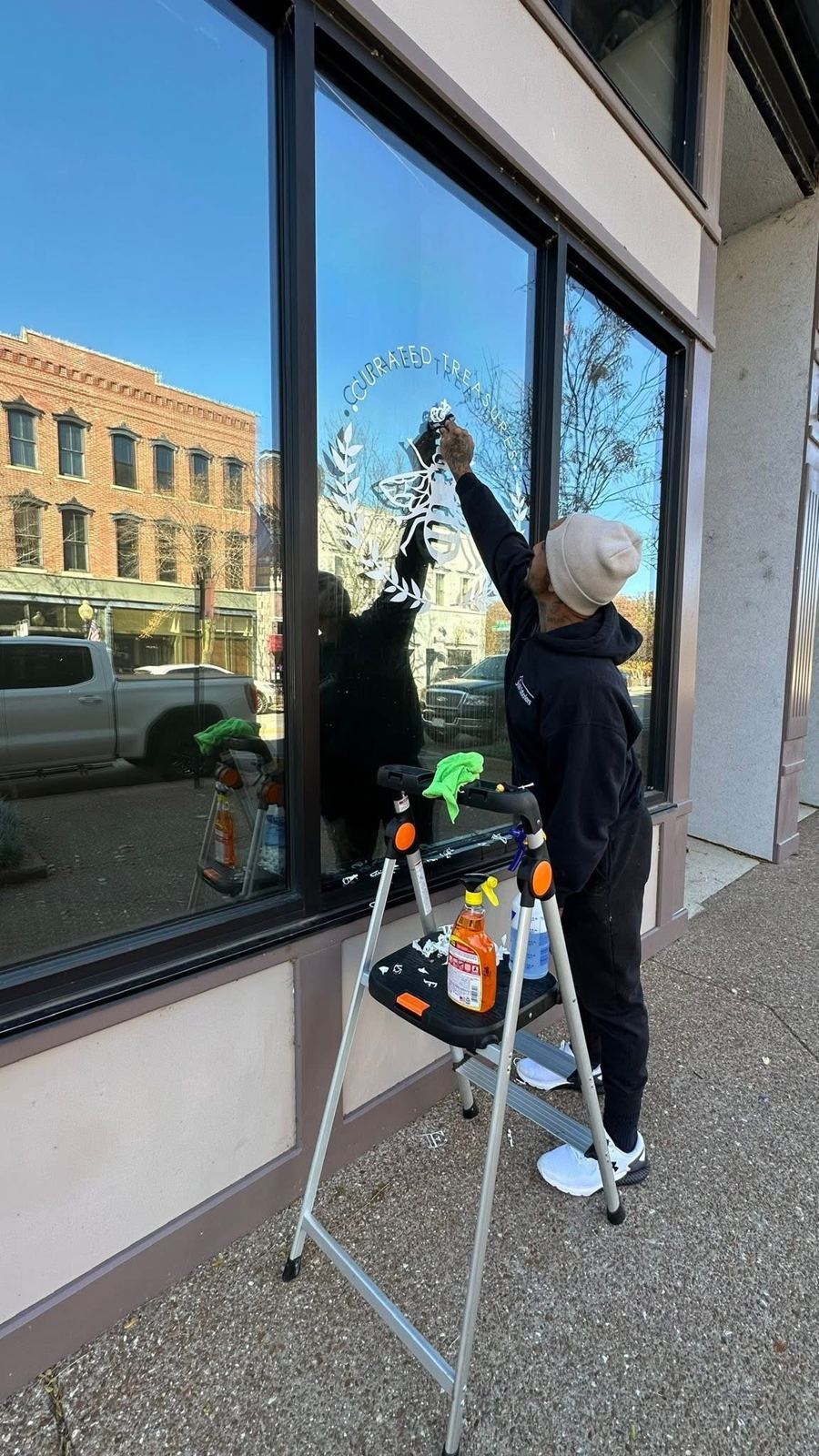 Cleaning storefront glass downtown